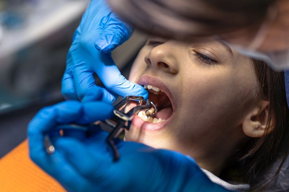 a girl is getting dental treatment